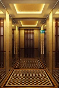 Modern elevator interior with warm lighting and elegant design for Maan Bangladesh Limited office building.